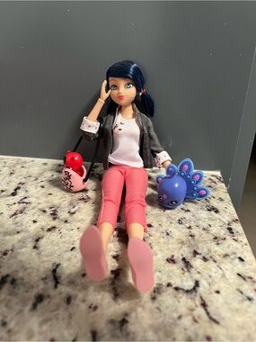 Blue-Haired Fashion Doll with Pink Outfit and Purple Pet